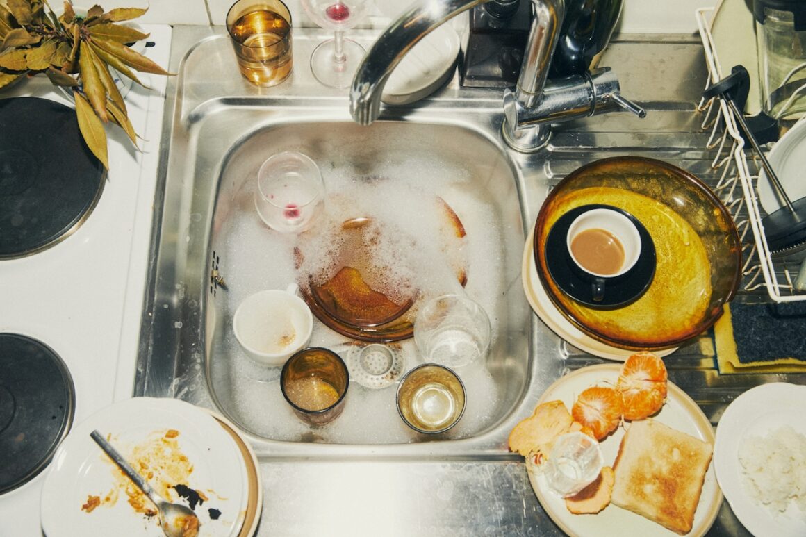 Dirty dishes soaking in a sink