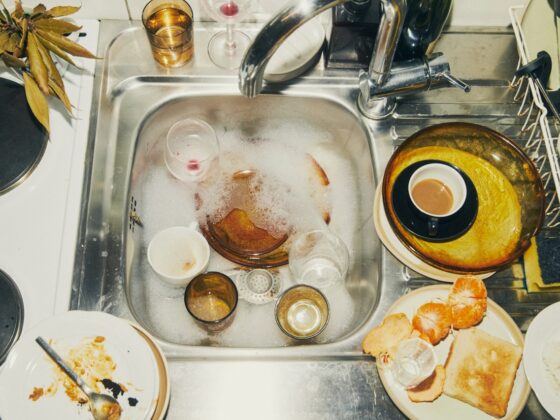 Dirty dishes soaking in a sink