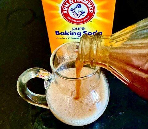 Vinegar and baking soda poured into a glass measuring cup, fizzing on contact